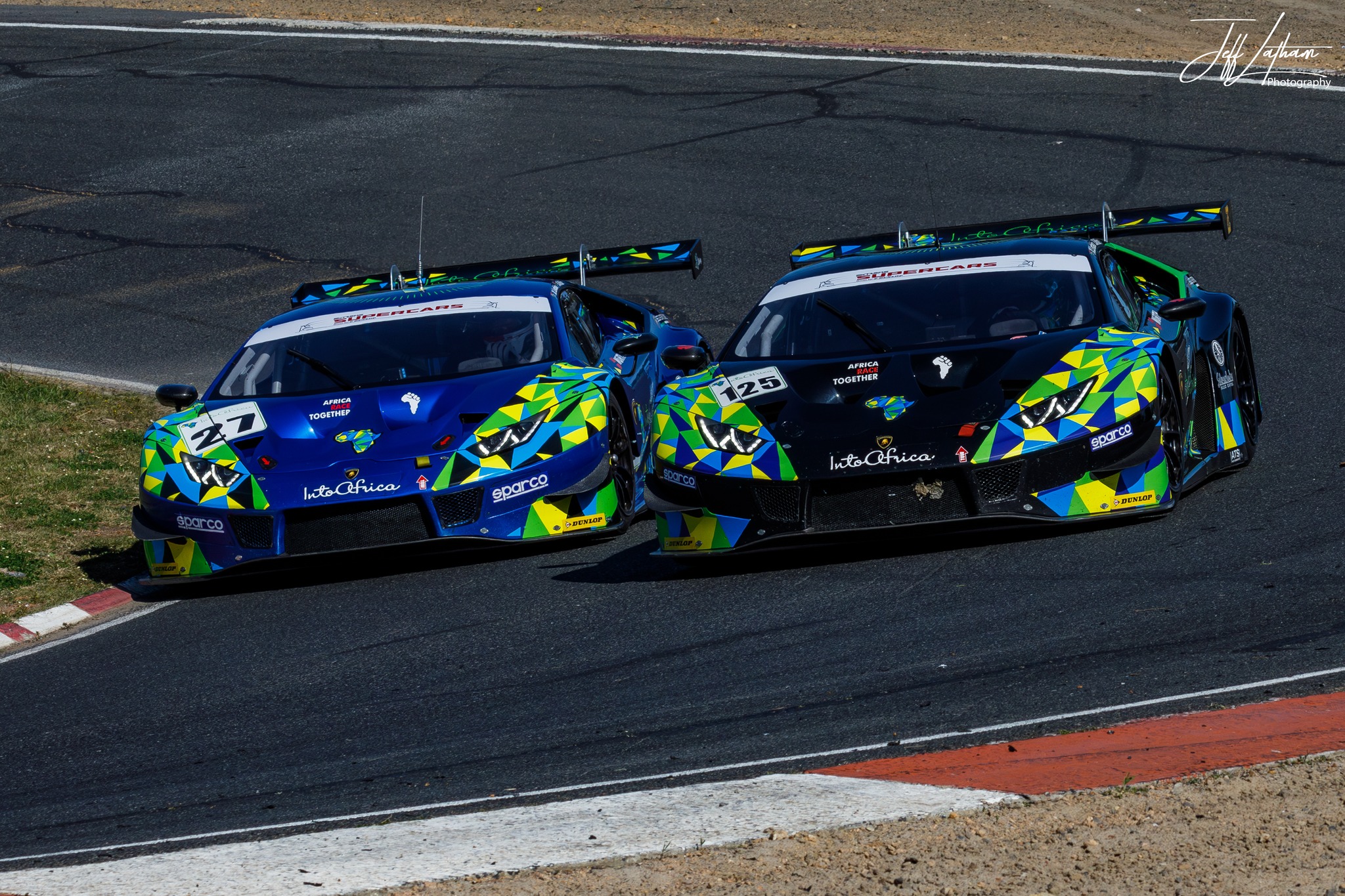 Two into africa lamborghini's racing down a track